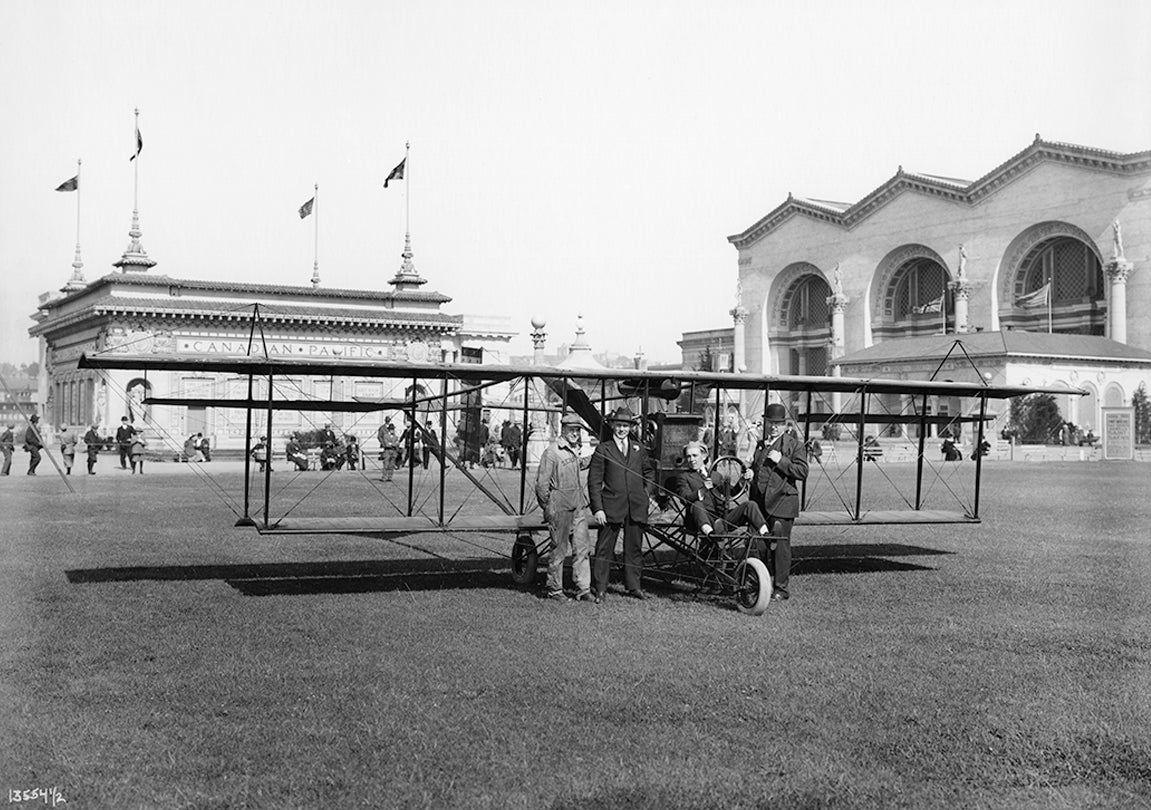 Art Smith with his mechanic (at far left) and two representatives from the Masters Spark Company at the Panama-Pacific International Exposition, San Francisco  1915