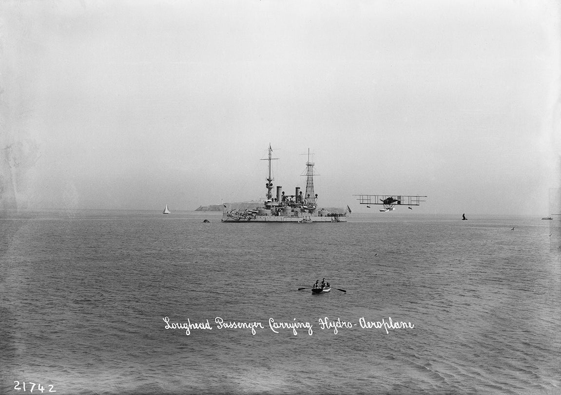 Loughead Brothers’ Alco Hydro-Aeroplane Model G passing the battleship USS Oregon, San Francisco Bay 1915