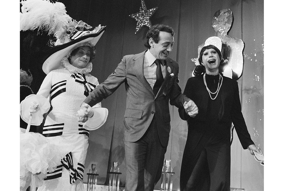 José Julio Sarria, Supervisor Harvey Milk, and Mavis (Marc “Marvin” Sterling, 1928-87) at the Empress Coronation, presenting a check from an anonymous donor to purchase uniforms for the first Gay and Lesbian Freedom Marching Band  October 28, 1978