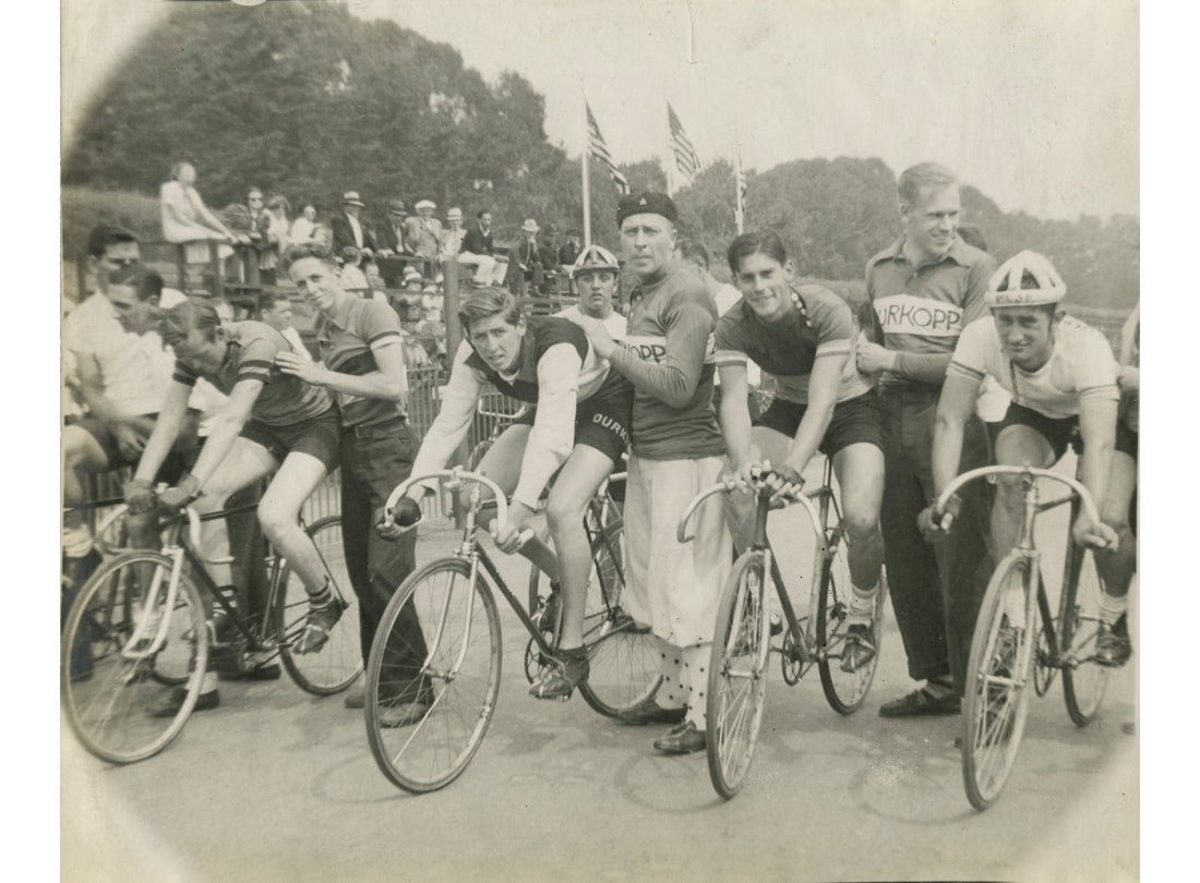 Trainers, wearing Dürkopp jerseys, with four cyclists, Golden Gate Park Polo Field, San Francisco  1939