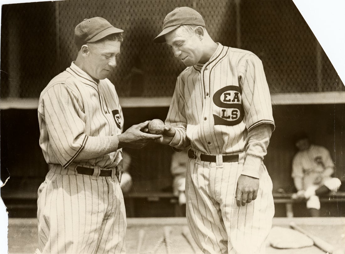 Seals players “McCrea and Rego” looking at a baseball