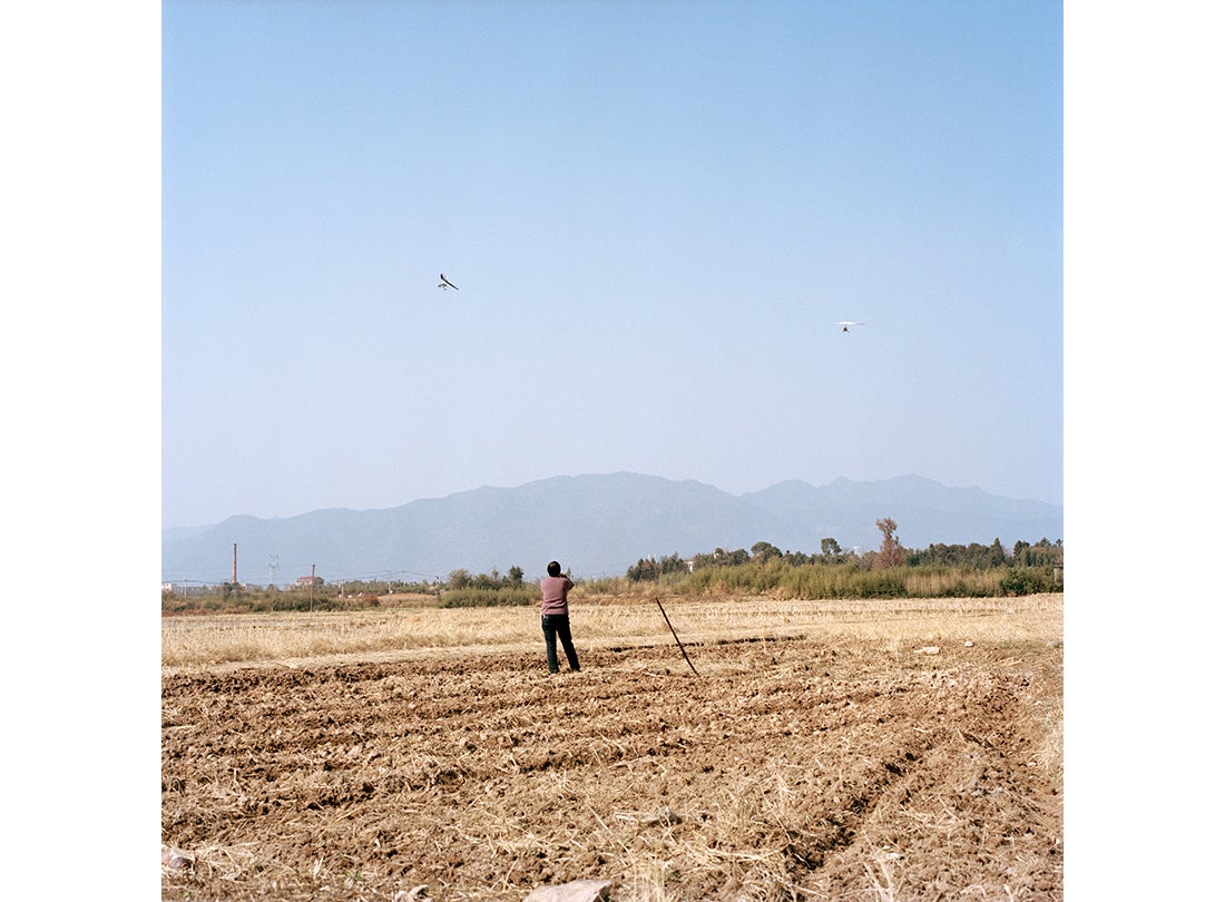 A farmer watching aircraft flying in the sky  2015