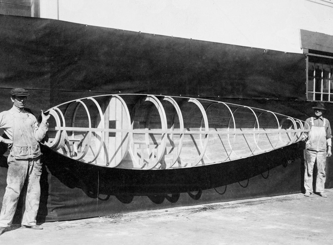 Workers holding a half-skinned fuselage frame for a Loughead Model S-1, with “Happy” Hopkins at the tail, Santa Barbara, California  1919