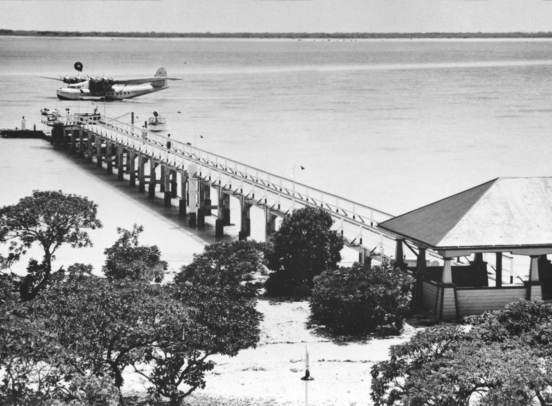 Passenger dock and Pan American Airways Martin M-130 moored in lagoon, Midway Island c. 1937 