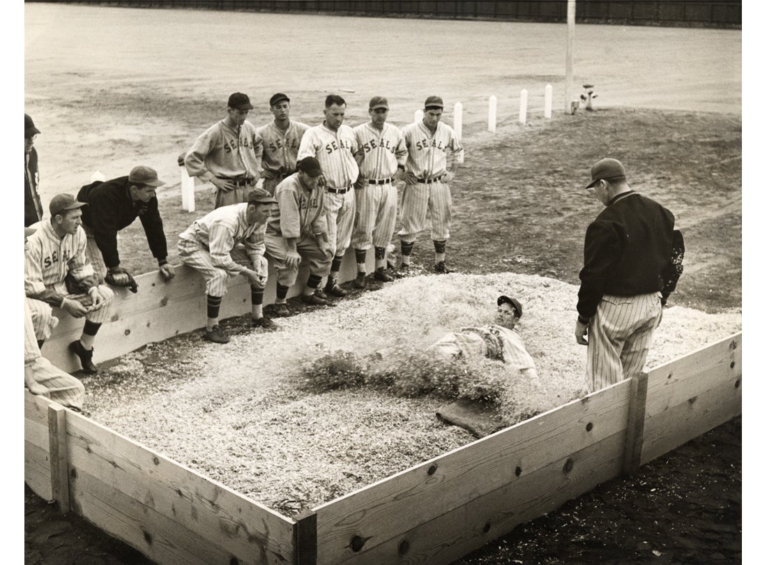 Dario Lodigiani of the Oakland Oaks sliding into third base 