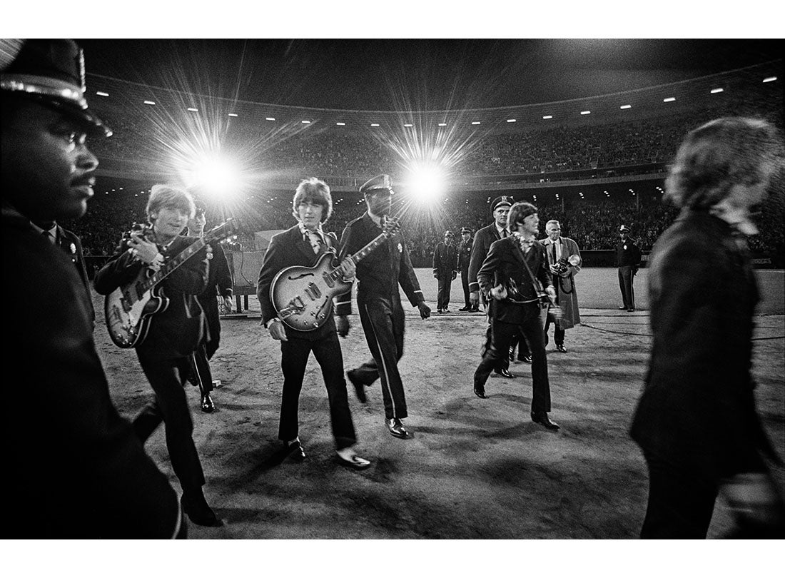 The Beatles walk across the field to the stage at Candlestick Park  August 29, 1966
