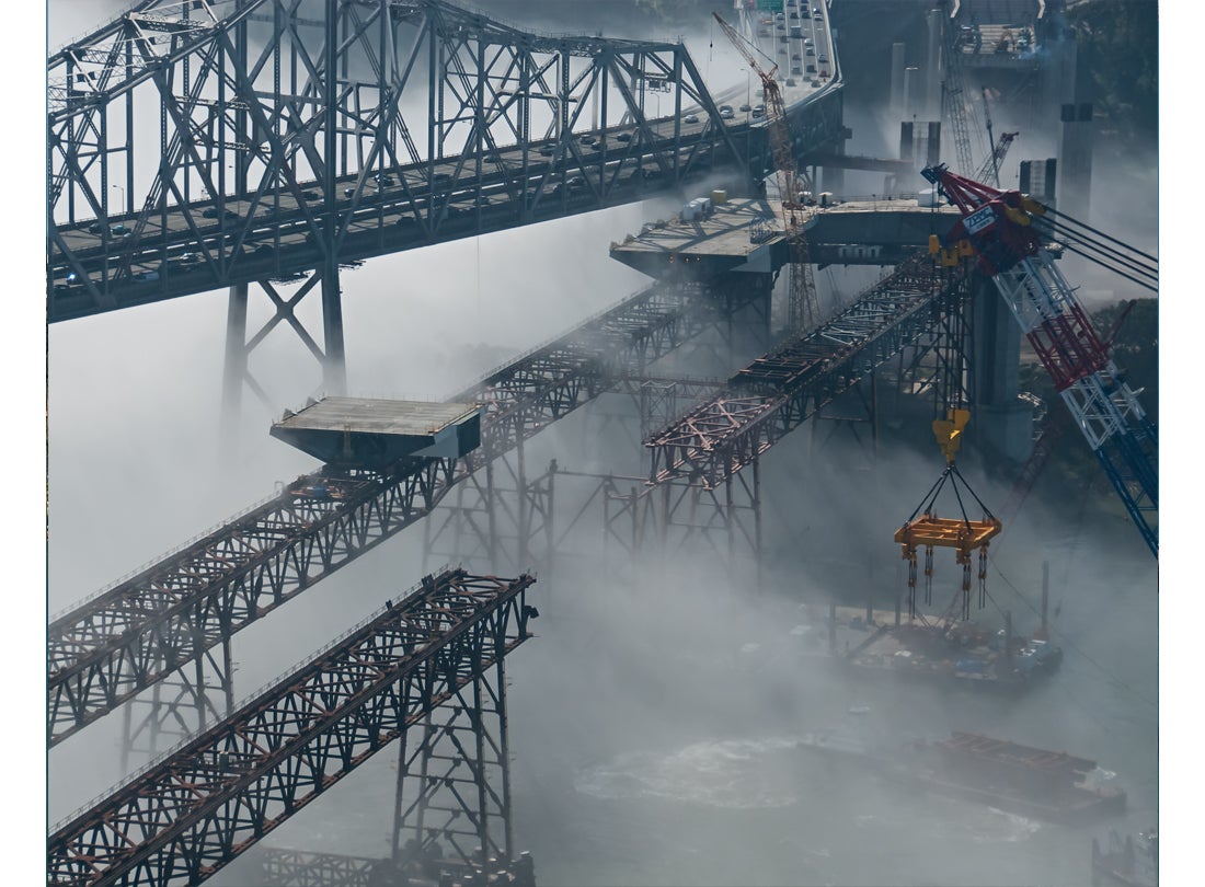 Steel-deck sections glide across falsework