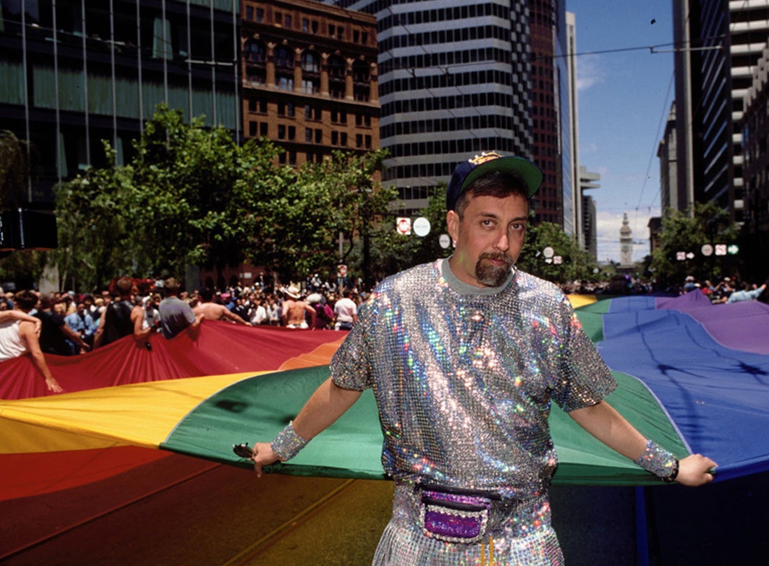 Gilbert Baker with portion of the mile-long rainbow flag on Market Street during the LGBT Pride Celebration in San Francisco