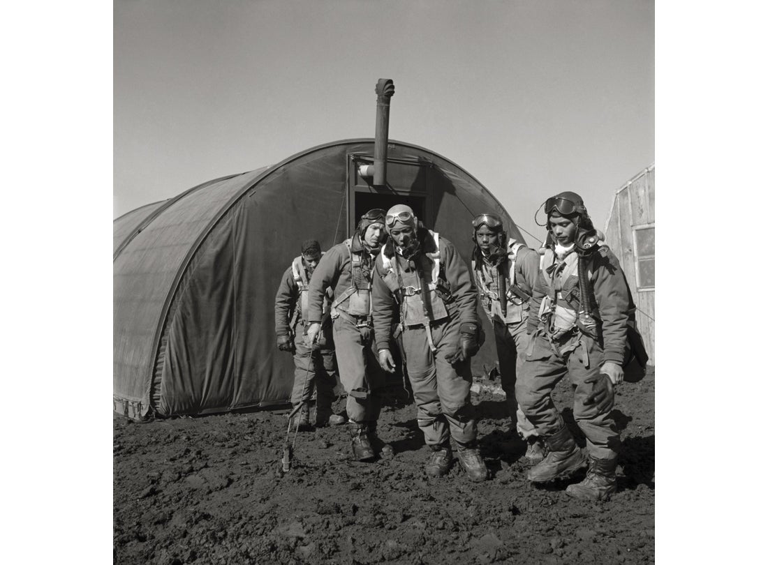 Pilots from the 332nd Fighter Group exiting the parachute room: (L-R) Richard S. Harder, unidentified pilot, Thurston L. Gaines, Jr., Newman C. Golden, Wendell M. Lucas  March 1945