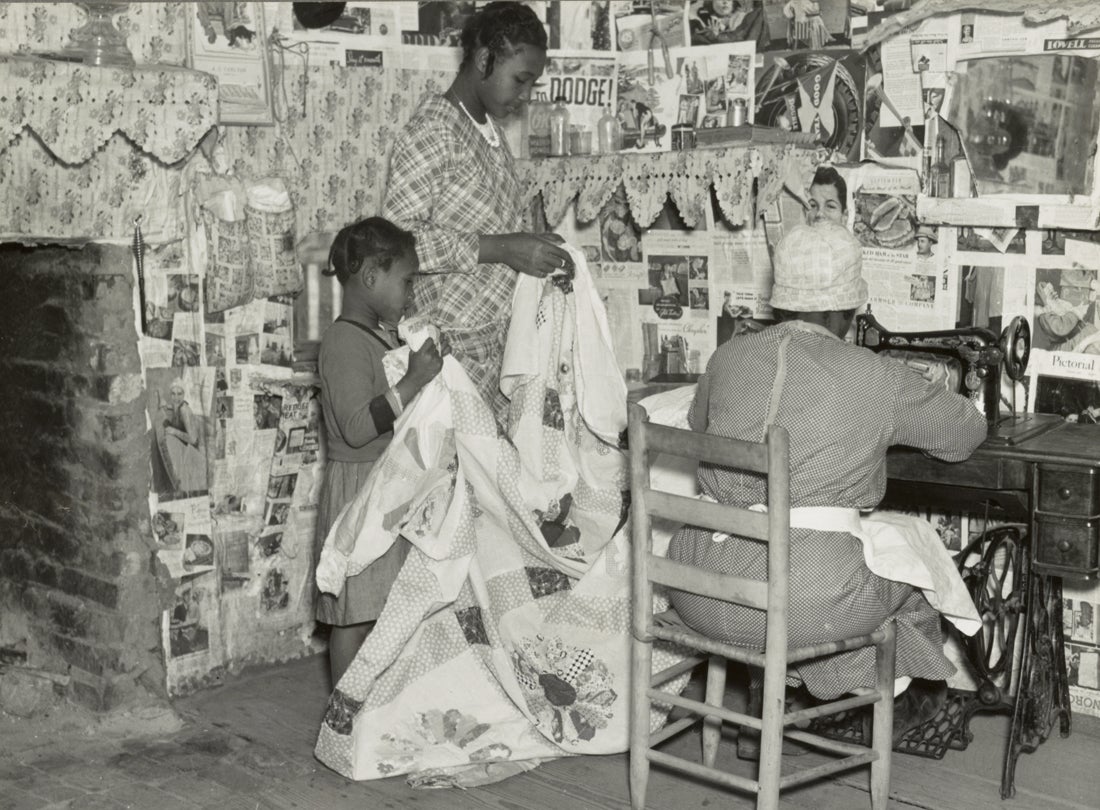 Jennie Pettway and another girl help the quilter Jorena Pettway construct a quilt Gees Bend, Alabama 1937