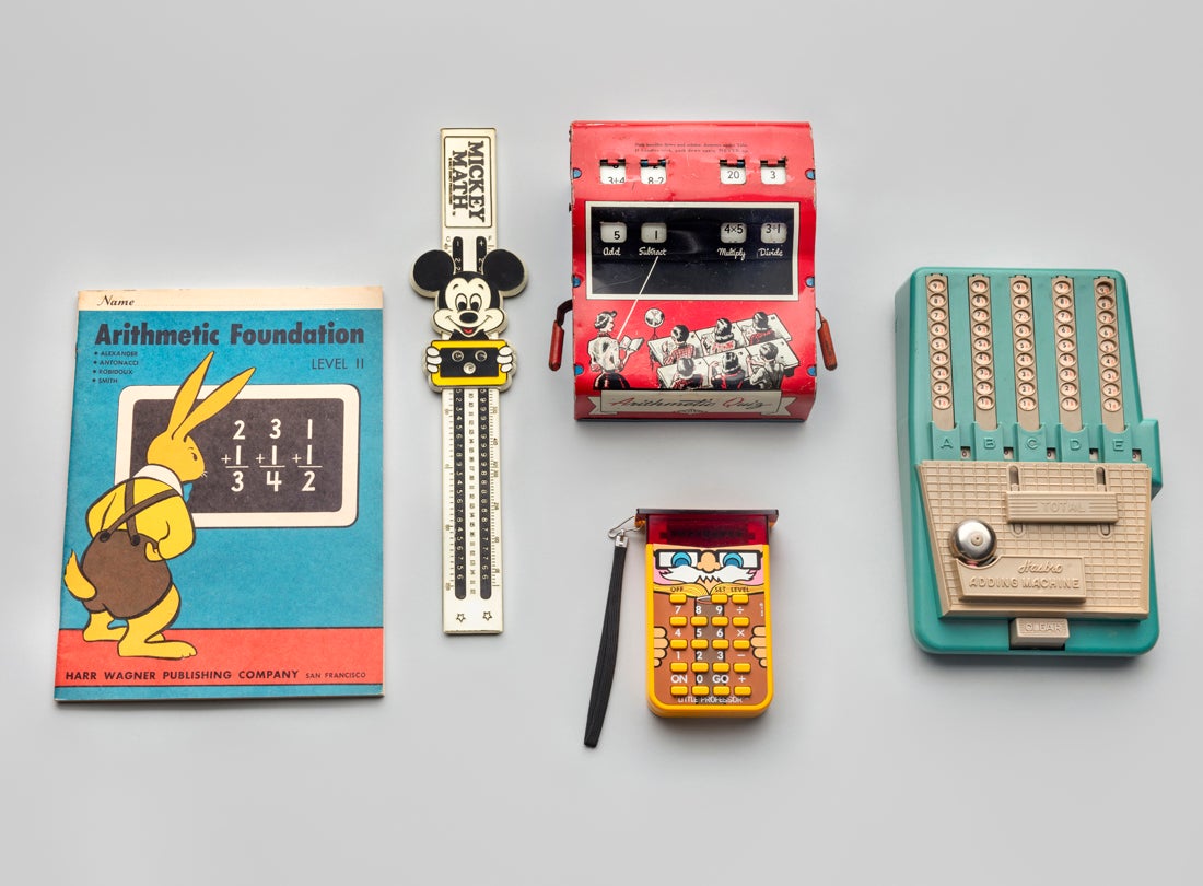 Arithmetic Foundation book and Arithmetic quiz  c. 1940s; Mickey Math and Toy adding Machine  c. 1960;  Little Professor  1976