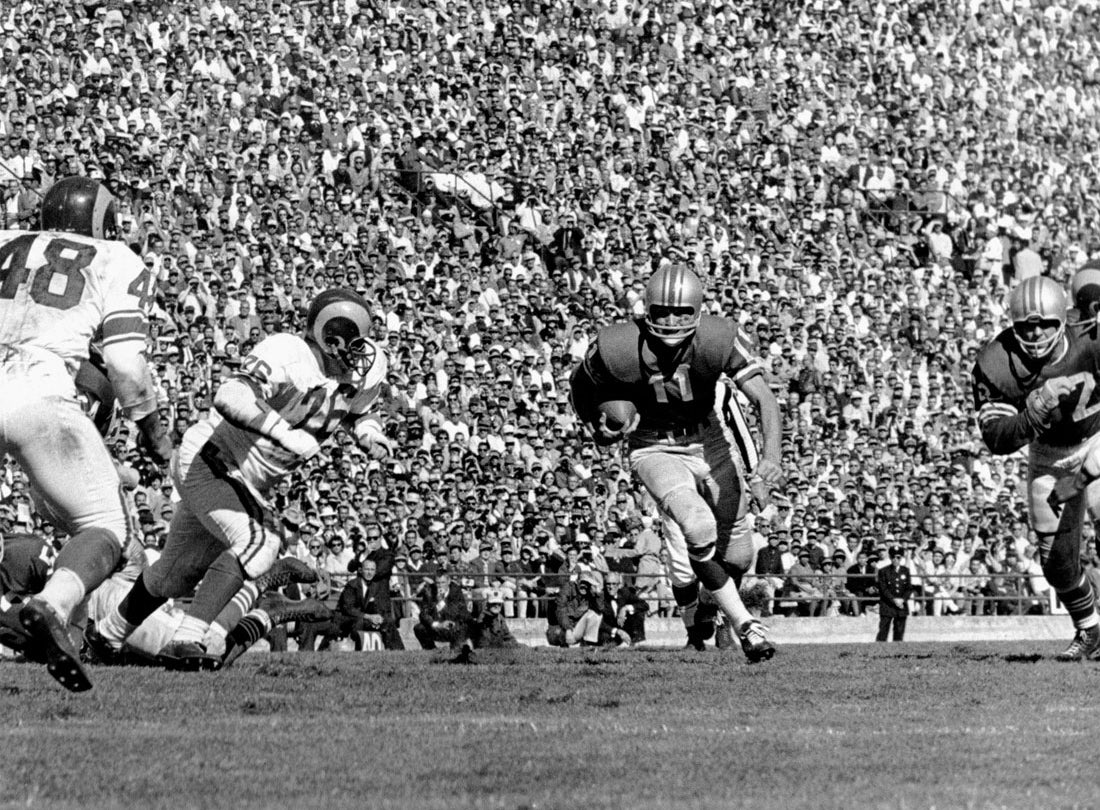 Quarterback Bobby Waters rushes from the shotgun formation for eleven yards during a 35-0 victory over the Los Angeles Rams at Kezar Stadium