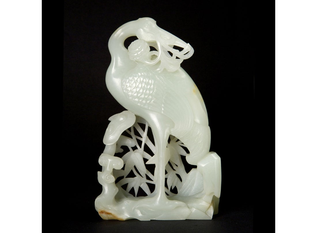 Crane carrying a branch of marigold