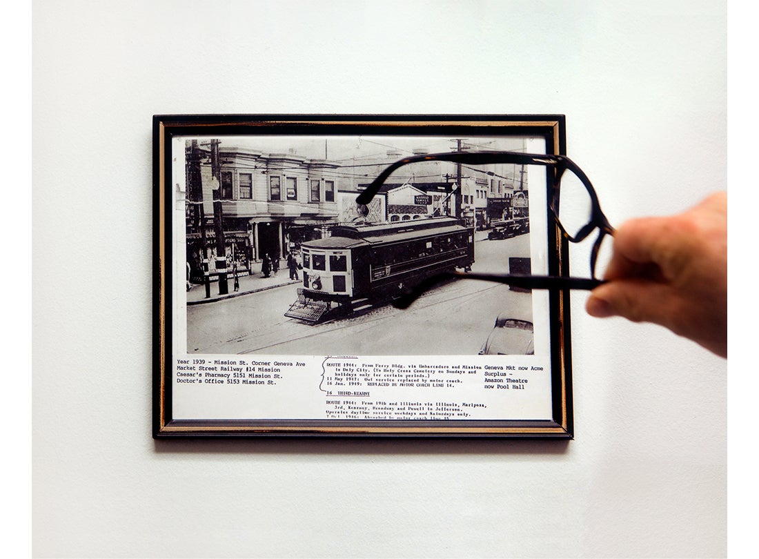 Bill, owner of Acme Surplus, pointing to a photo in his office of the studio building in 1939  2017