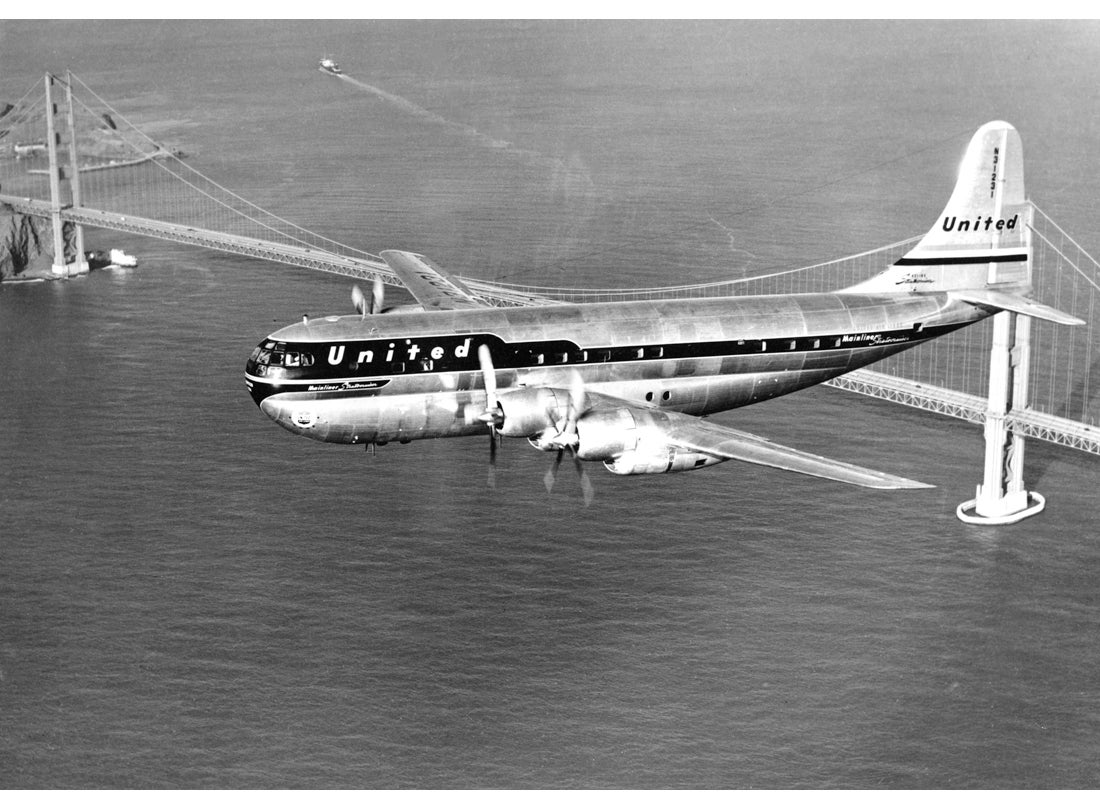 United Air Lines, Boeing 377 Stratocruiser above the Golden Gate Bridge  c. 1955