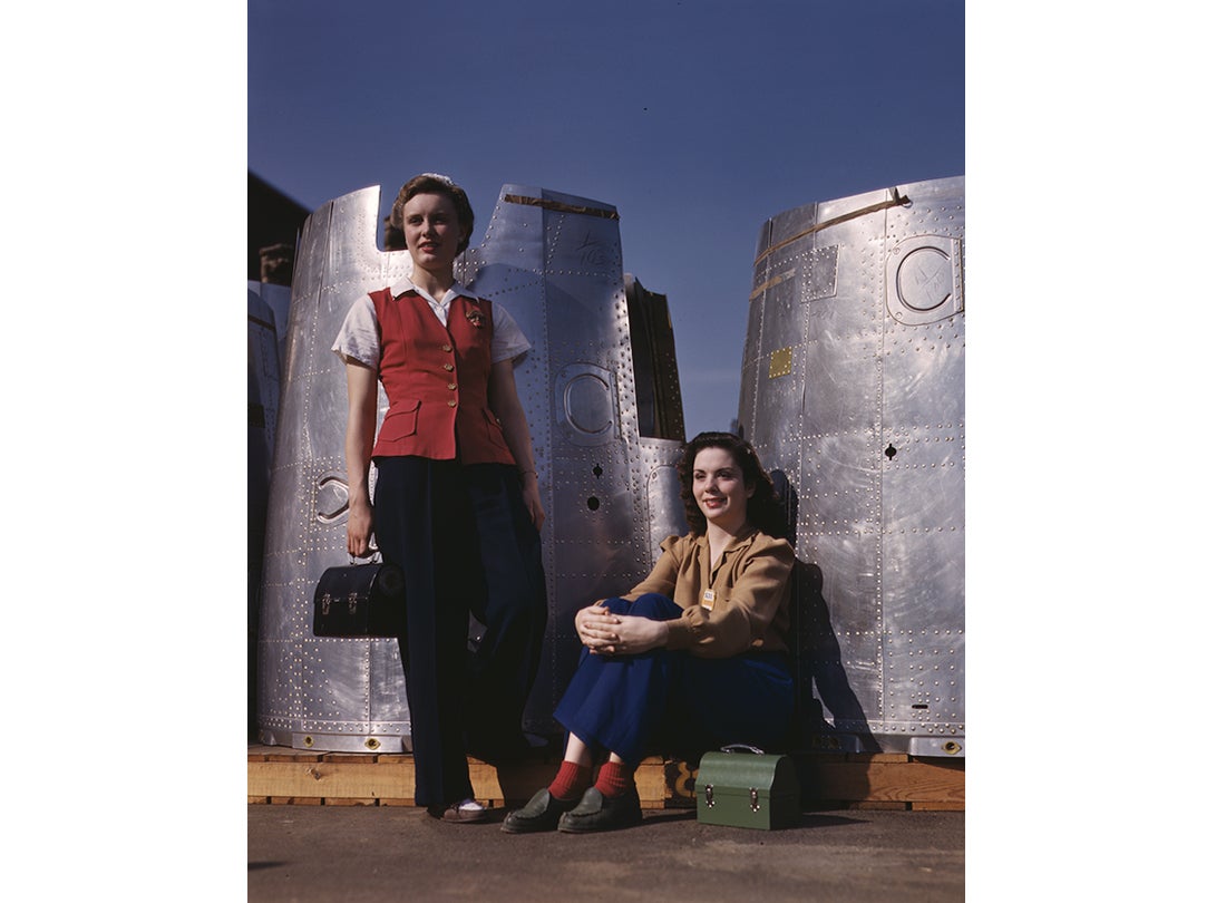 Assembly line workers enjoy a lunch break with heavy bomber nacelle parts in the background at the Douglas Aircraft Company plant