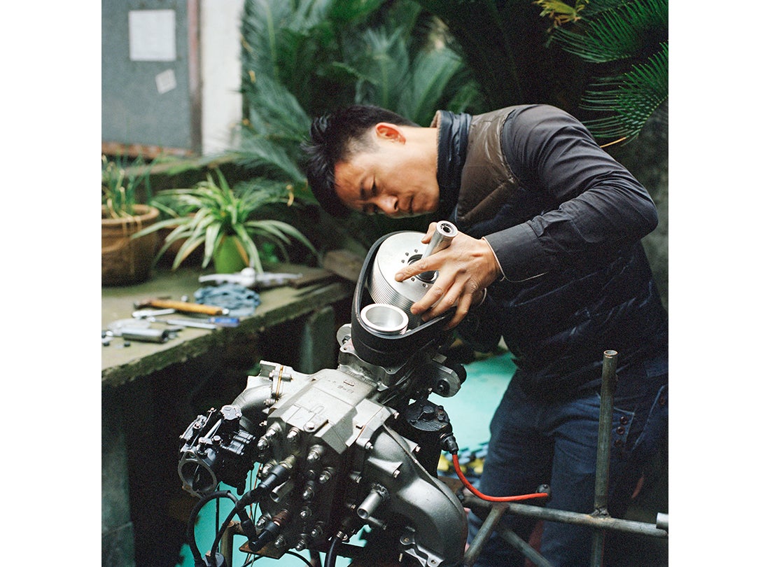 Wang Qiang refits the engine for his airplane in his backyard in Cixi, Zhejiang Province  2015