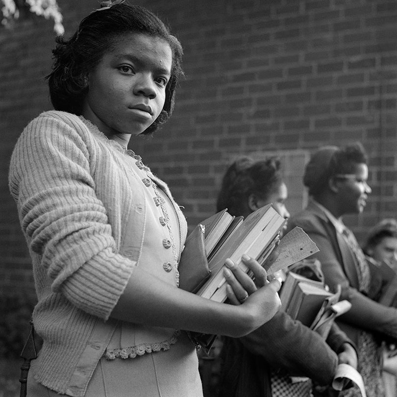 Schoolgirl waiting to get on bus at small town in Tennessee  1943