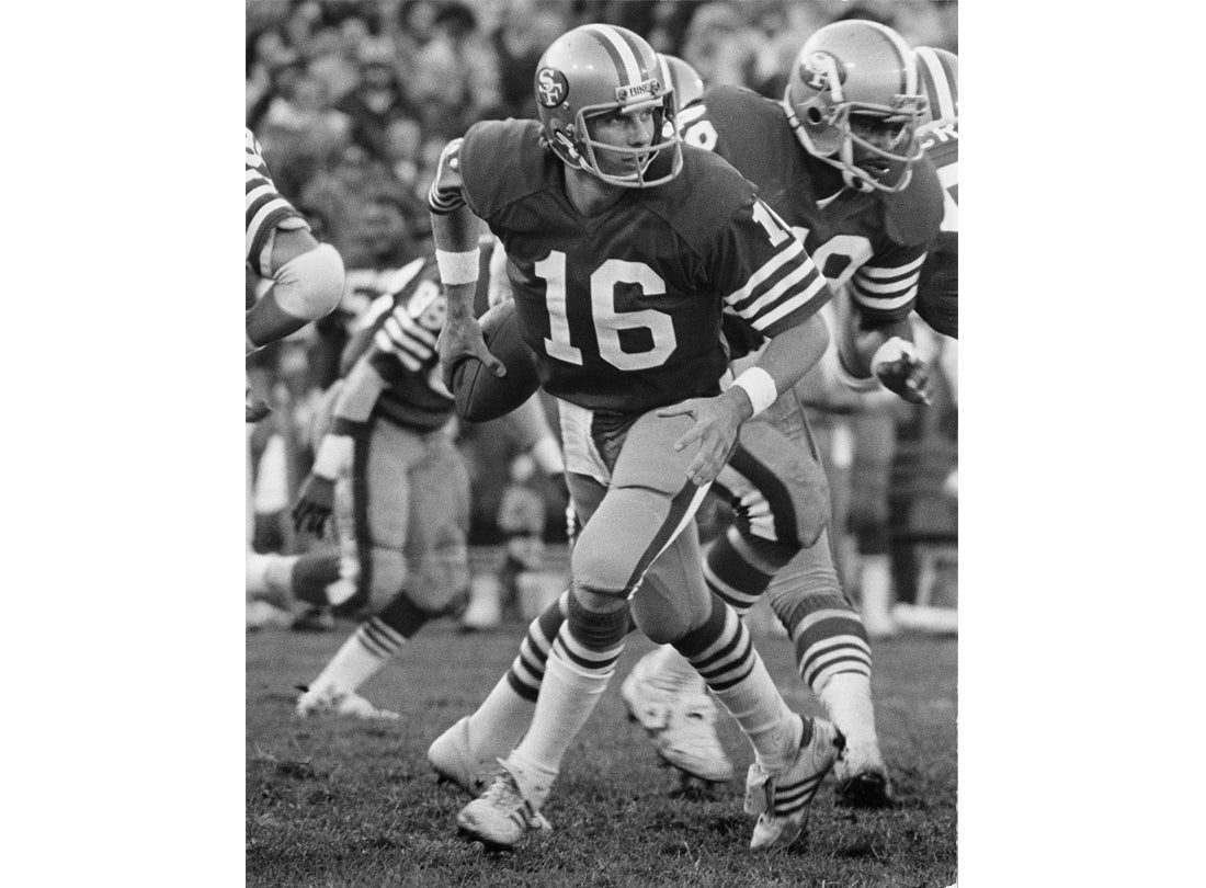Quarterback Joe Montana rolls out to his right during a 17-10 victory over the New York Giants at Candlestick Park  November 29, 1981