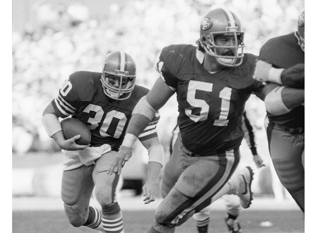 Running back Bill Ring (30) follows guard Randy Cross (51) during a 35-21 victory over the Tampa Bay Buccaneers at Candlestick Park  December 4, 1983