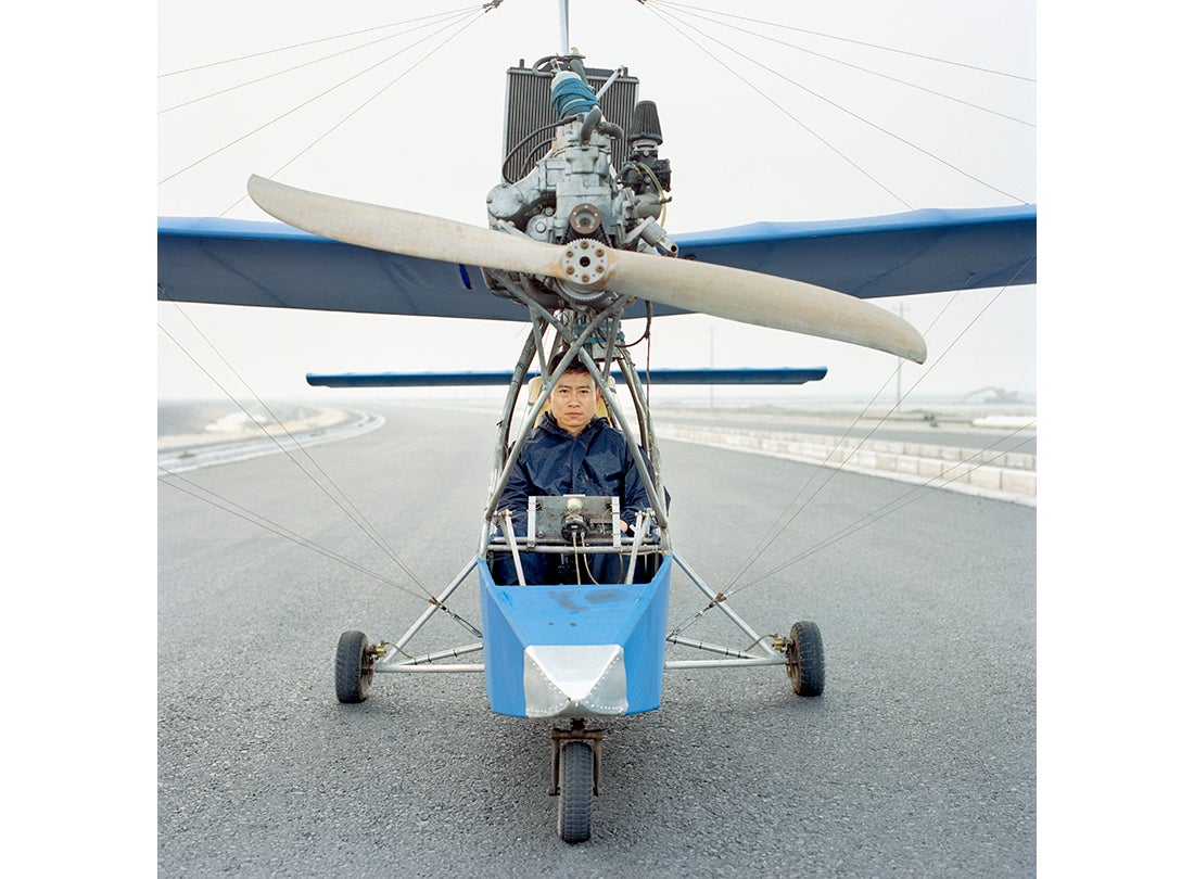 Wang Qiang sits inside the Wang Qiang No.2, a fixed-wing aircraft that uses a Yamaha engine from a boat. He spent approximately four months and $5,000 to construct the aircraft, which can reach an altitude of nearly 5,000 feet  2015