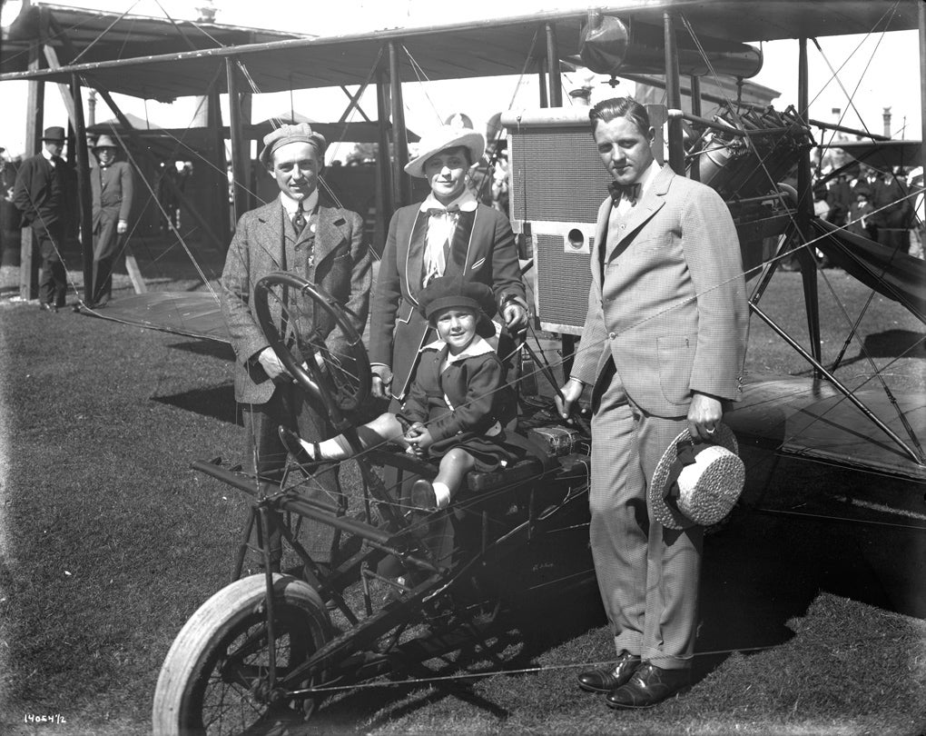 Art Smith (at left) with his biplane and fairgoers at the Panama-Pacific International Exposition, San Francisco  1915