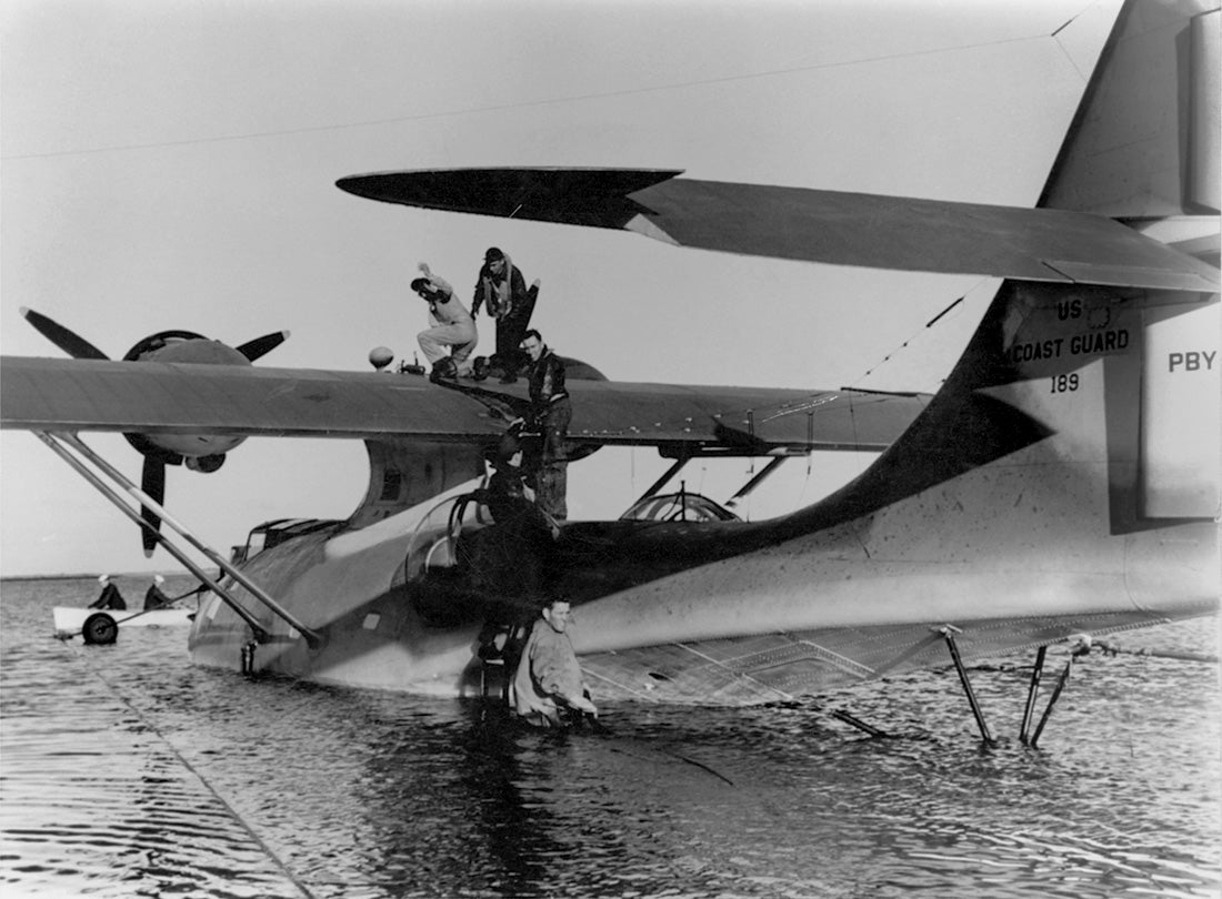 Consolidated PBY-5A Catalina seaplane is filled with fuel before a flight to Hawai’i  
