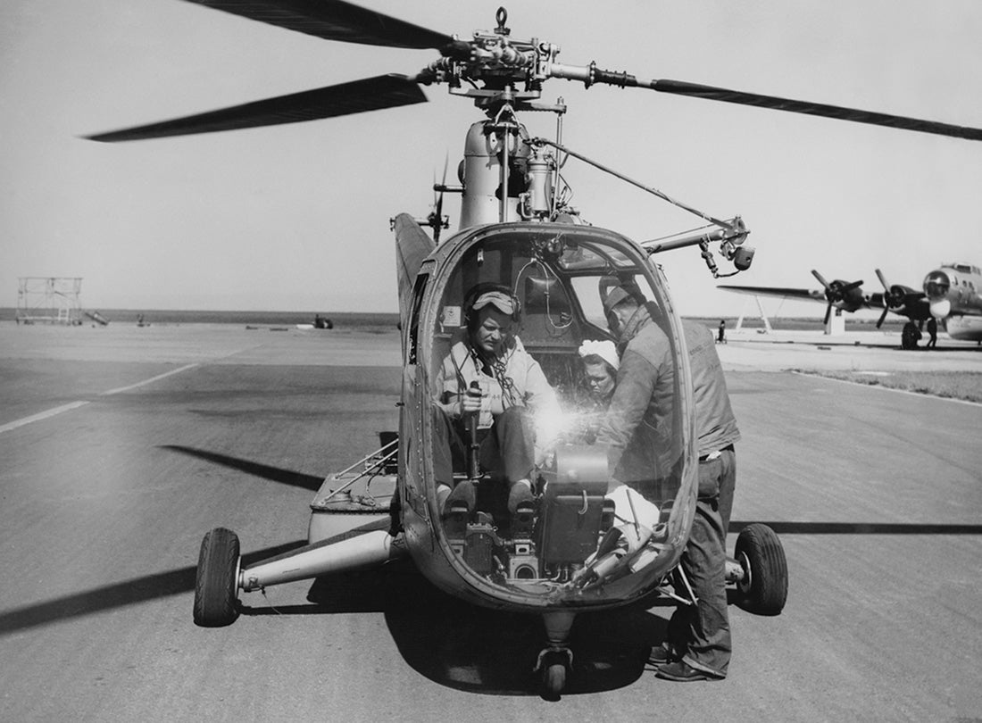 Sikorsky R-6A Hoverfly helicopter is readied for flight with Boeing PB-1G in background at Coast Guard Air Station San Francisco