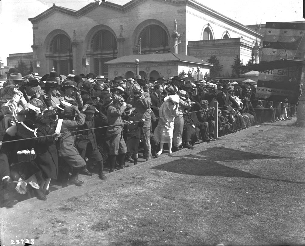 Spectators in the prop wash as Art Smith revs his engine for takeoff at the Panama-Pacific International Exposition, San Francisco  1915