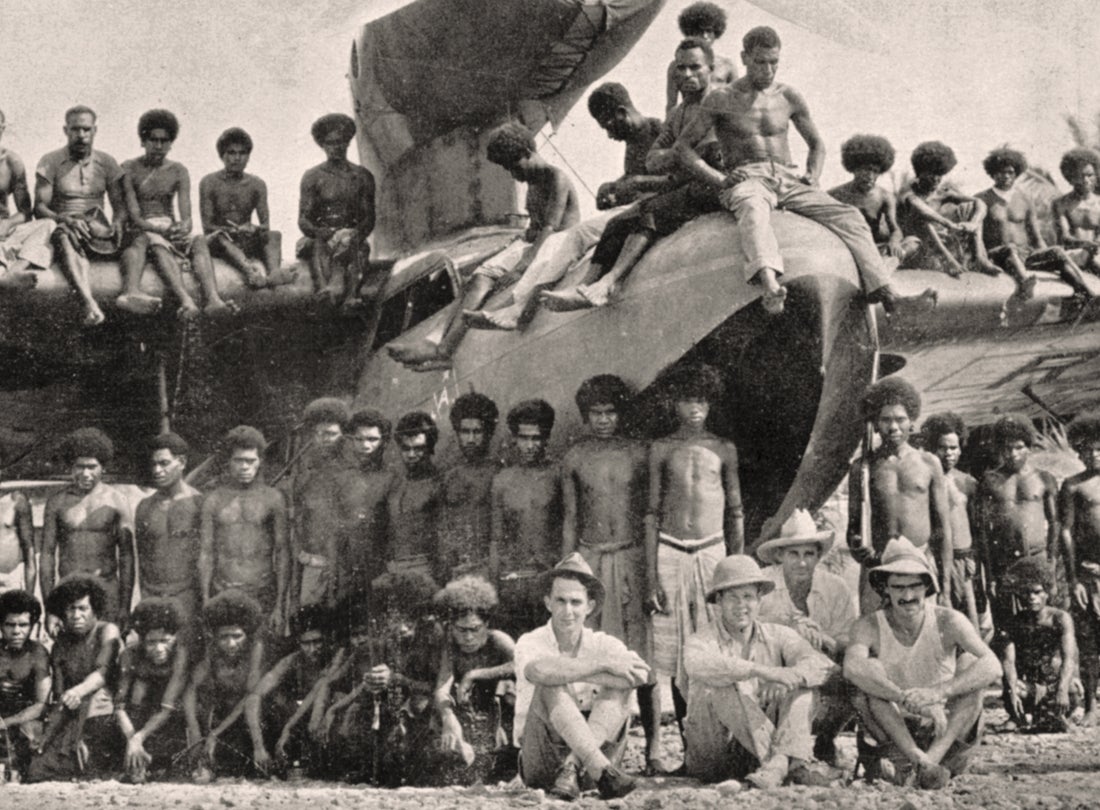 Archbold Expedition members and New Guineans pose with the expedition’s Fairchild 91 amphibian aircraft  1936