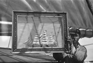 A fisherman holds a half model he made aboard the Star of Holland, a three-masted barque built in 1885  c. 1920Collection of the San Francisco Maritime National Historical ParkJ10.36,684psR2013.0301.08