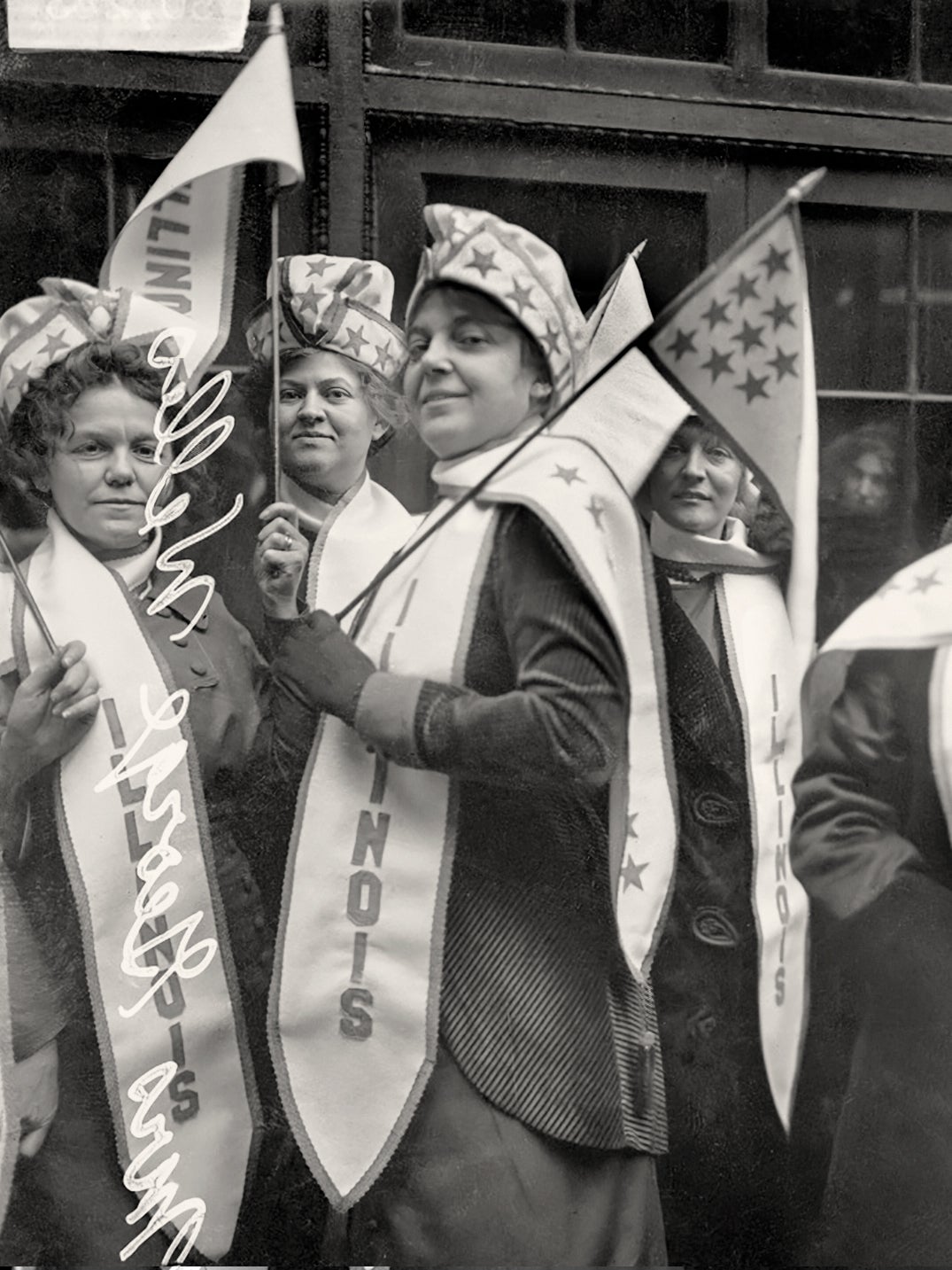Clara Barck Welles, holding flag, with members of the Illinois delegation preparing to leave for the Woman Suffrage Procession in Washington, DC  March 1913