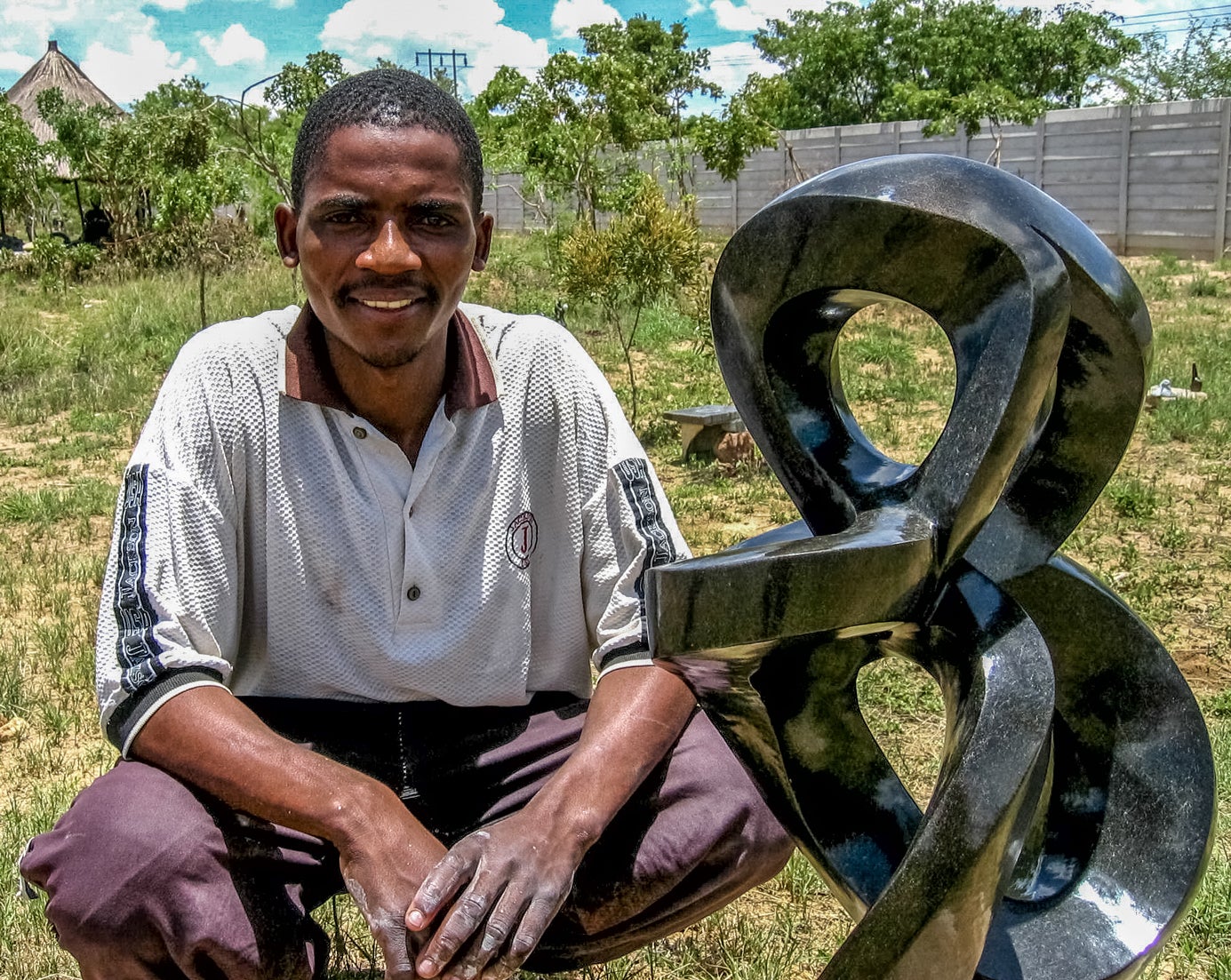 Nesbert Mhute beside one of his sculptures  2008  Chitungwiza, Zimbabwe