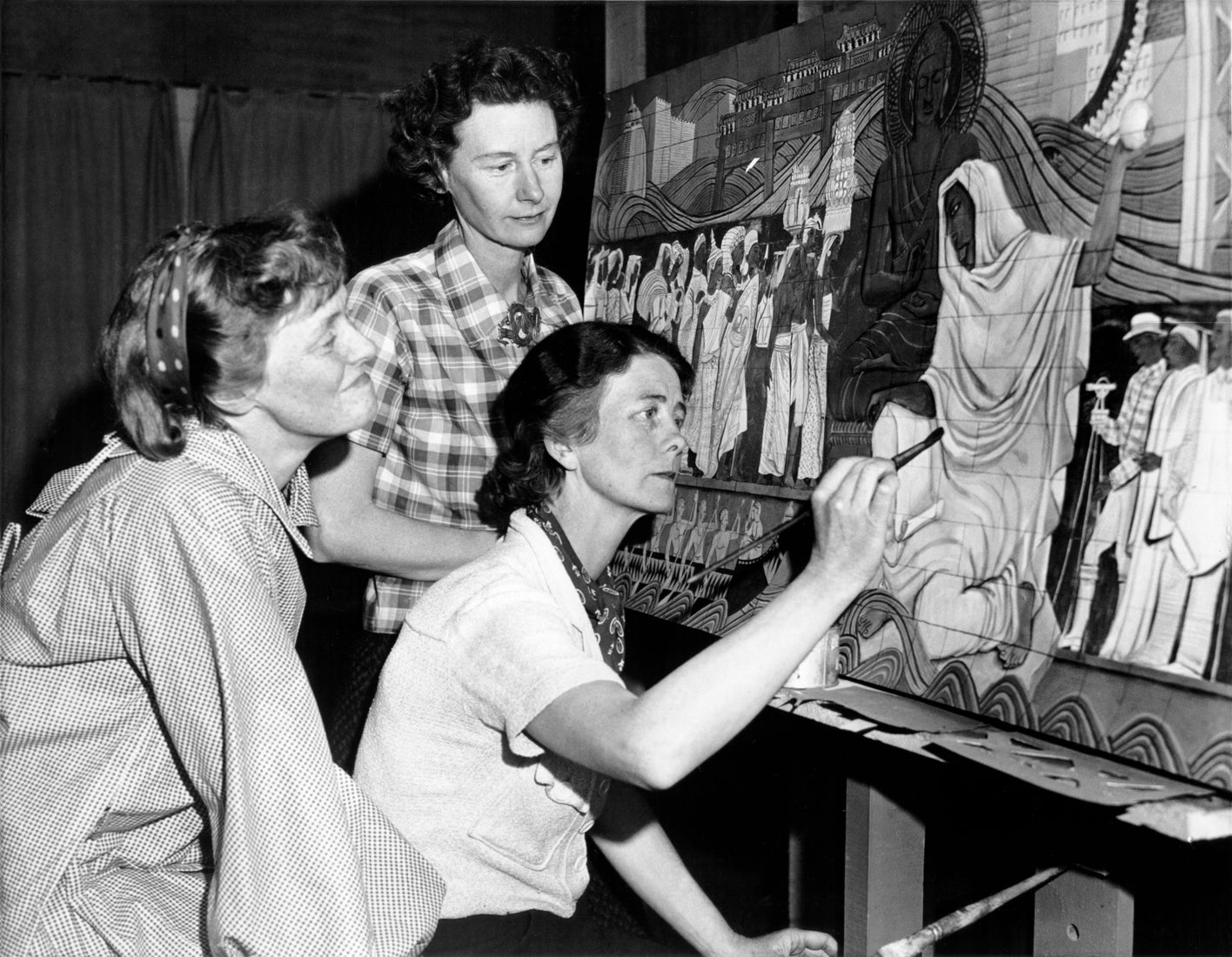 Esther, Margaret, and Helen Bruton, from left to right, work on a rendering for  The Peacemakers mural  1938 Courtesy of San Francisco History Center, San Francisco Public Library AAC–8855 R2022.0606.002