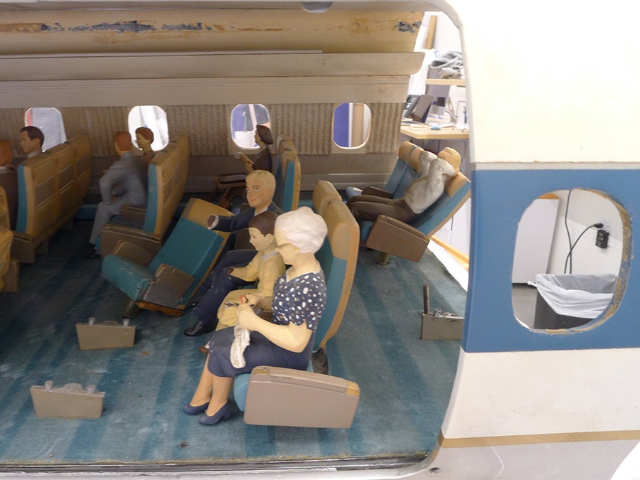 Conserving a Cutaway Model: United Air Lines Douglas DC-8 Middle section, before and after treatment (fills include one row of seats, seatback for knitting figure, arm and pad of paper for girl, and hand for male figure)