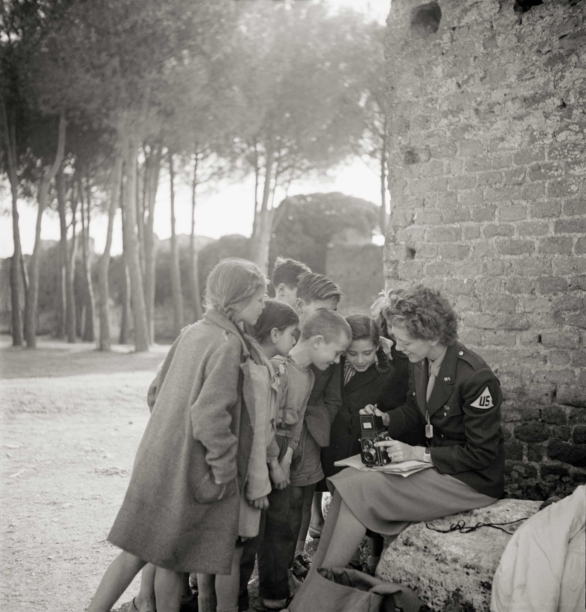Photographer Toni Frissell shows her camera to children in Europe  1945 photograph Collection of Library of Congress LC-DIG-ppmsca-19005  R2021.2001.001