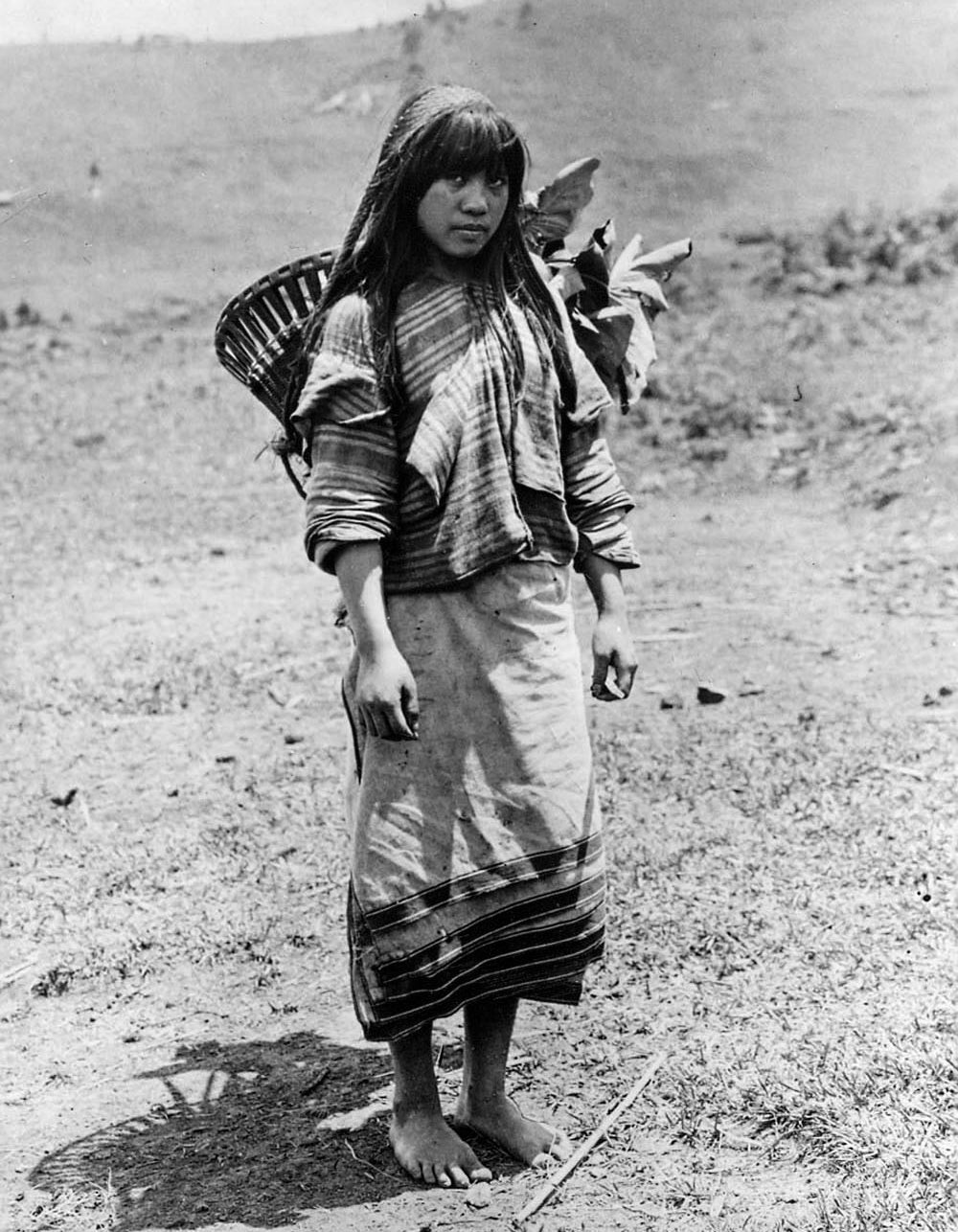 An Ibaloi woman carries taro leaves home in a kayabang early 1900s;  Luzon Cordillera, Philippines Fowler Museum at UCLA, Day Collection; R2013.0801.062