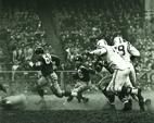 New York Giants quarterback Frank Gifford rushes in the final minutes of regulation during the 23-17 overtime victory by the Baltimore Colts over the Giants in the NFL Championship Game  December 28, 1958; Photo: Pro Football Hall of Fame]