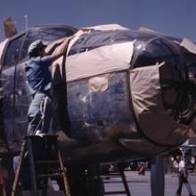 A North American Aviation B-25 Mitchell bomber is prepared for painting on the outside assembly line at the North American Aviation plant