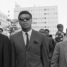 Muhammad Ali walking near San Francisco’s Civic Center with a Nation of Islam security guard on his right and sports journalist Robert Lipsyte—who covered Ali from 1964 until his death—on his left. Ali later spoke to thousands outside City Hall during a rally to protest war, racism, and poverty  April 27, 1968 