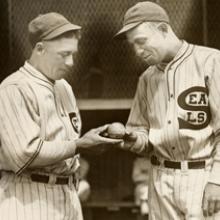 Seals players “McCrea and Rego” looking at a baseball