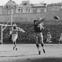 Halfback Hugh McElhenny receives a pass during a 17-13 victory over the Baltimore Colts before a crowd of 59,950 at Kezar Stadium and hundreds more crowding nearby rooftops  December 8, 1957