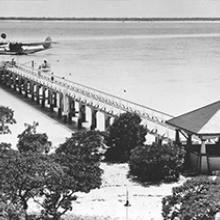Passenger dock and Pan American Airways Martin M-130 moored in lagoon, Midway Island c. 1937 