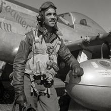 332nd Fighter Group Operations Officer Edward C. Gleed stands next to his North American P-51D Mustang March 1945