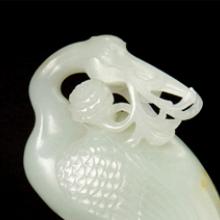 Crane carrying a branch of marigold