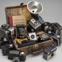 Suitcase with Cameras  1984–ongoing Mickey McGowan (b. 1946) suitcase, cameras, photographs, film canisters, negatives, pamphlets Courtesy of Mickey McGowan, Unknown Museum Archives L2023.0301.010.01, .03–.19