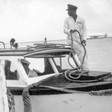 Launch and crew dockside with a Pan American Airways Martin M-130 in the lagoon, Midway Island 1938 