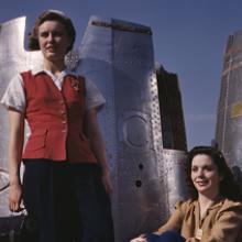Assembly line workers enjoy a lunch break with heavy bomber nacelle parts in the background at the Douglas Aircraft Company plant