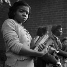 Schoolgirl waiting to get on bus at small town in Tennessee  1943