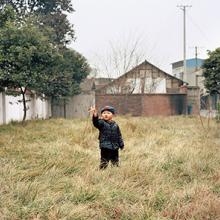 Wang Qiang’s son plays with a toy airplane  2015